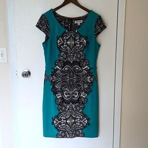 Shelby and Palmer teal dress with black lace patterns. Cap sleeve.